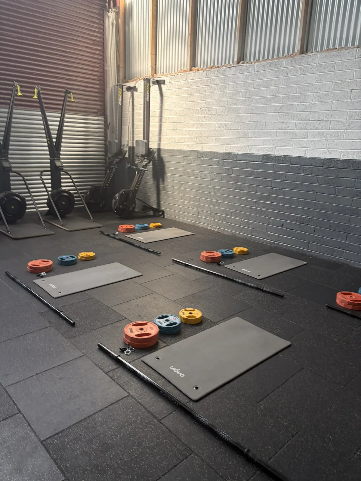 Barbell and mat stations prepared for a studio session