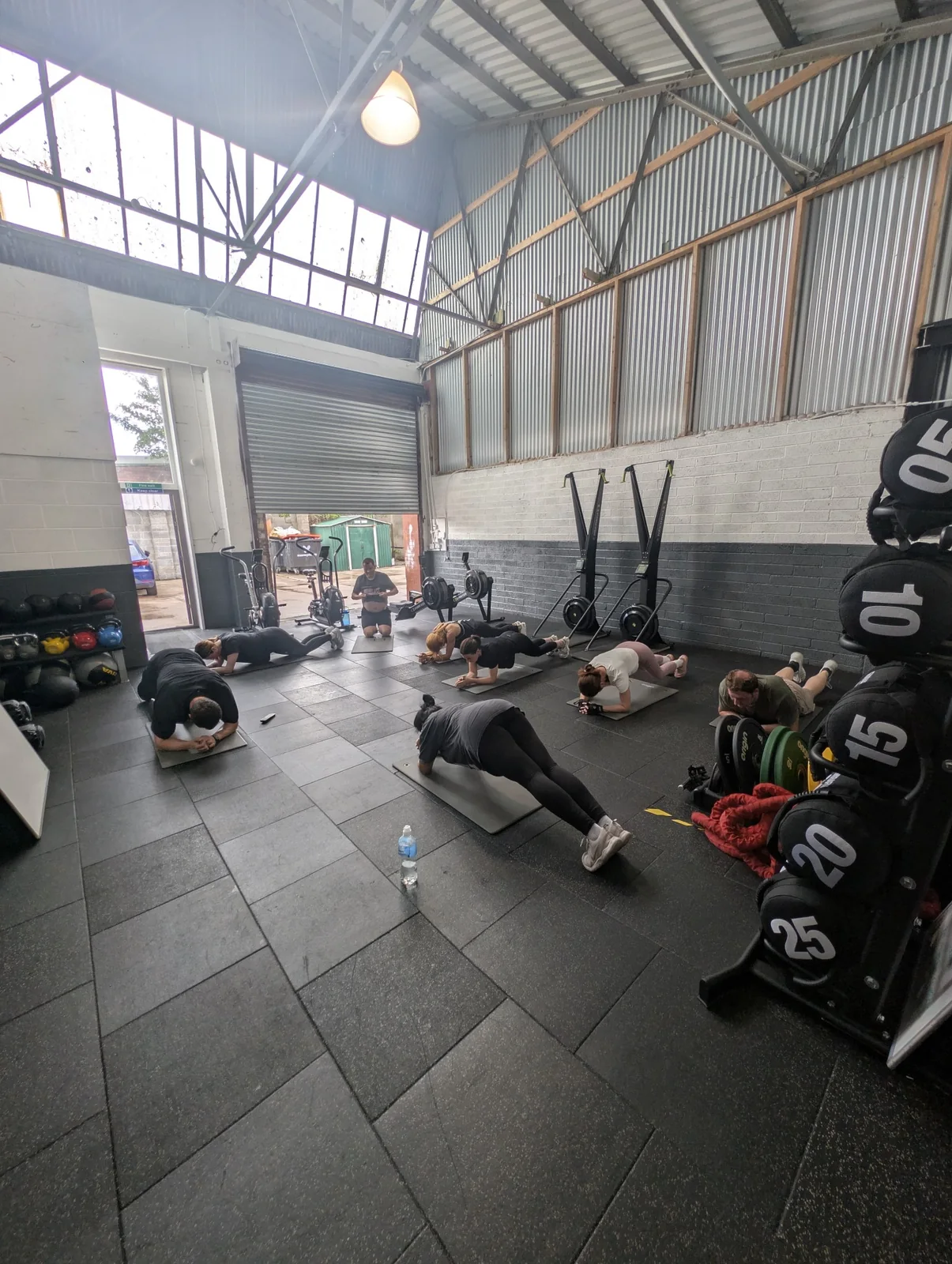 A coached class training across the Jake Barr Fitness studio floor