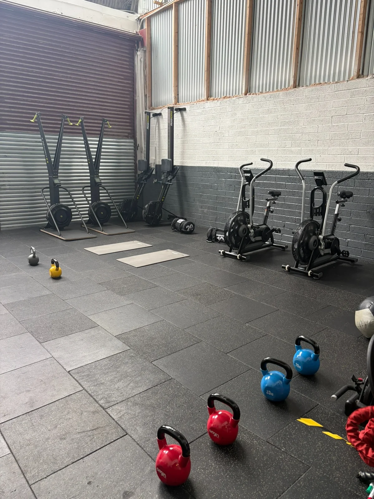 Kettlebells, cardio machines and training space inside the studio