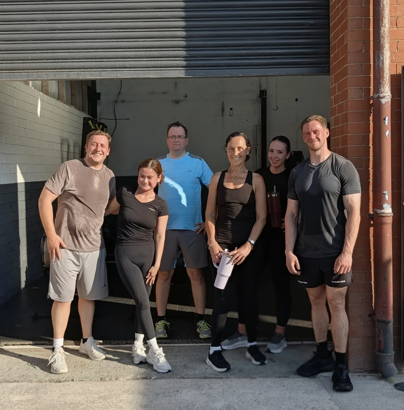 Members and Jake at the studio entrance
